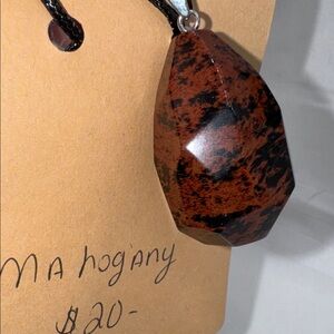 mahogany stone necklace 2” pendant on 9” cord the color is black and brown new